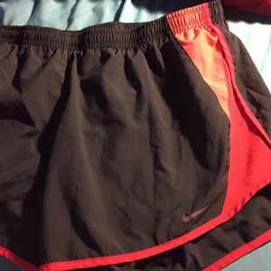 Nike gray and orange running shorts.
